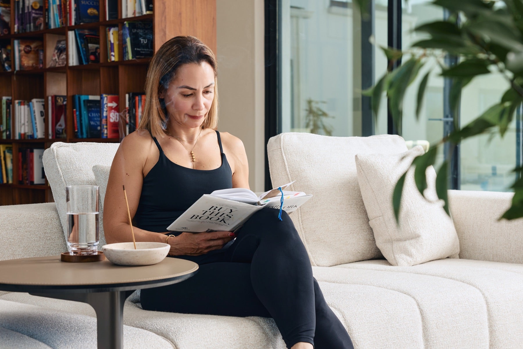 Woman winding down with a book as part of a calm evening routine.